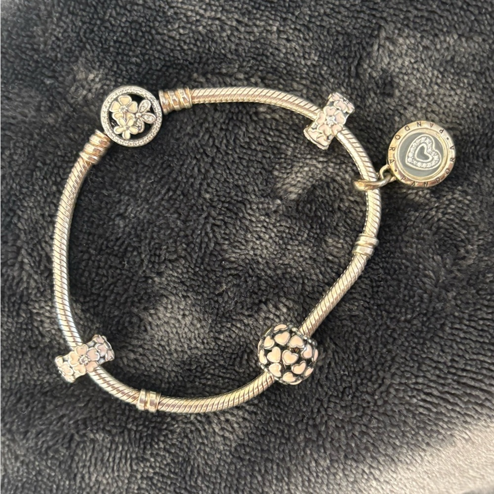 Pandora silver bracelet with 4 charms and flower clasp